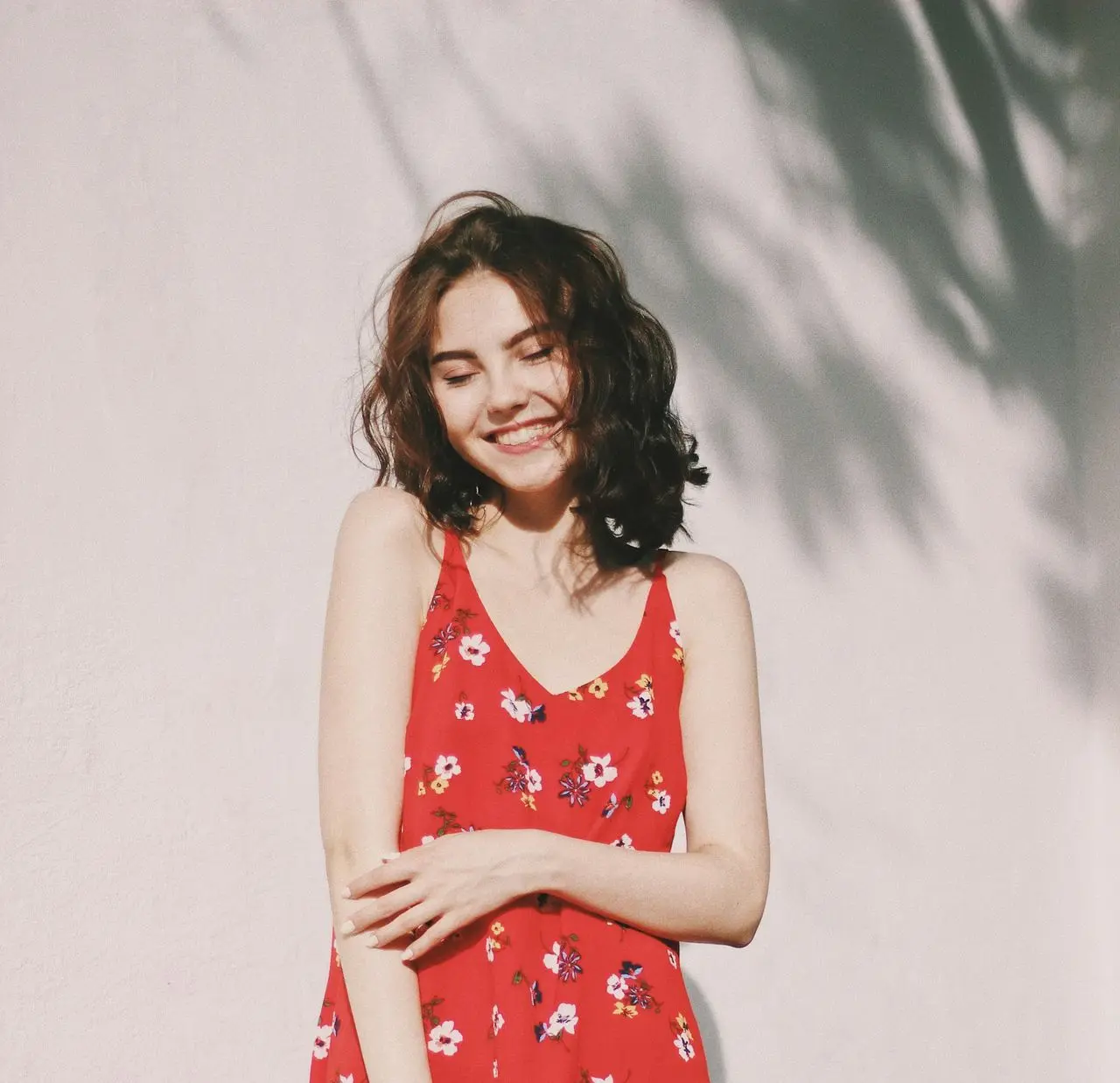 woman standing in front of white wall